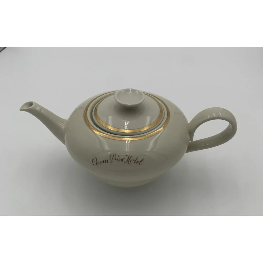 Vintage Rhenania Western Germany Teapot. Poreclain with gold trim around lid.